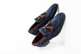 Navy blue suede loafers with brown leather tassels